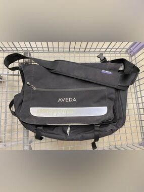 Patagonia 'Critical mass' messenger bag in black - AVEDA logo embroidered